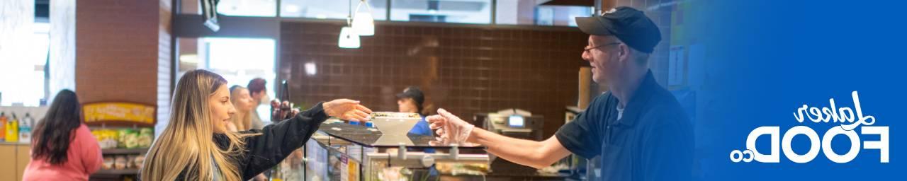 Student being served food at The Connection